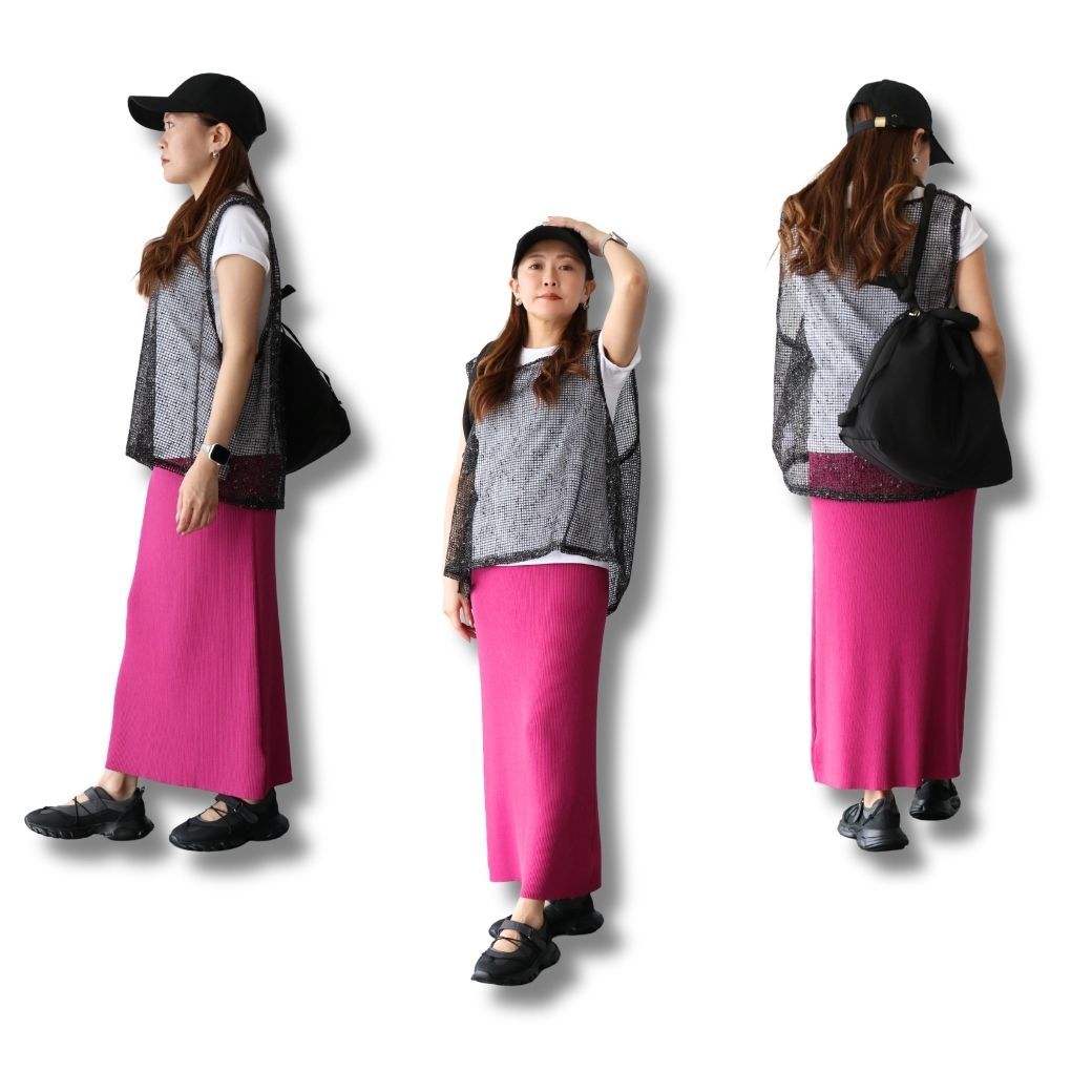 Woman in a pink skirt and gray vest, wearing a cap and sneakers.