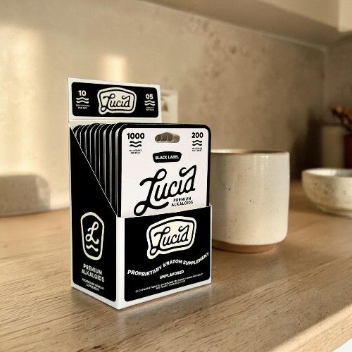 Packaging of Lucia brand materials on a countertop near a mug.