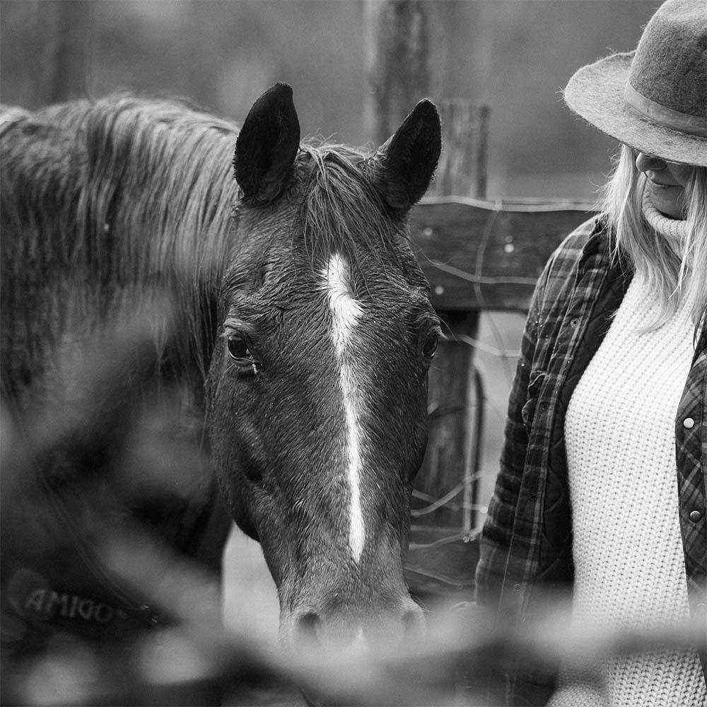 Black and white photo of a woman and her horse