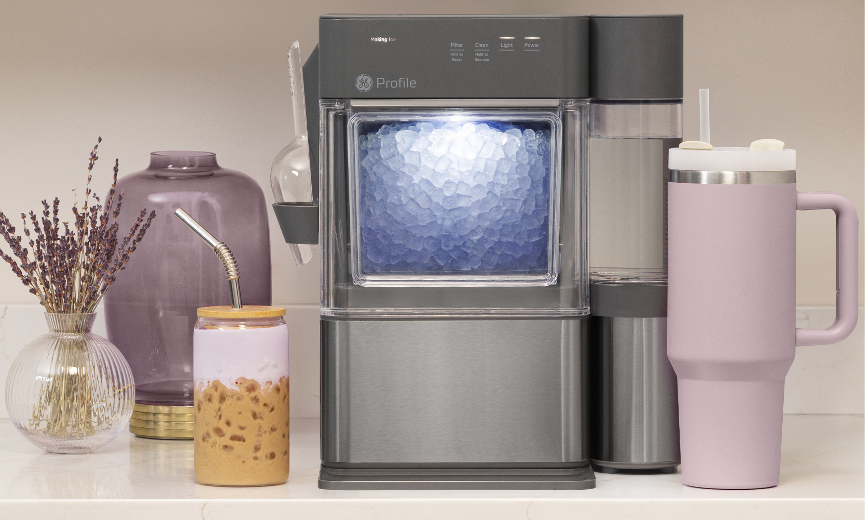 A beverage maker surrounded by various cups and decorative items.