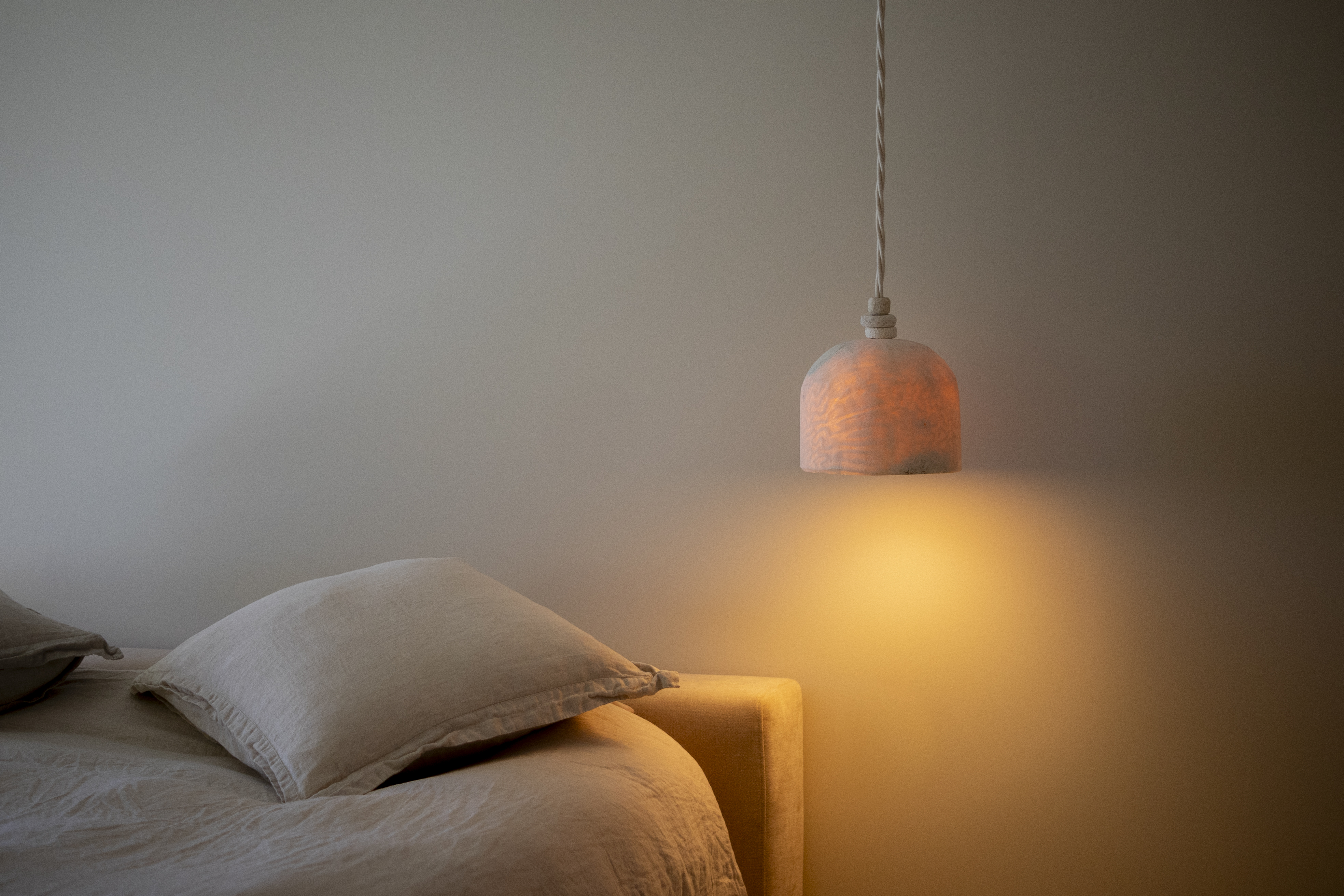 Fossil Coral Dome Hanging Pendant in a bedroom
