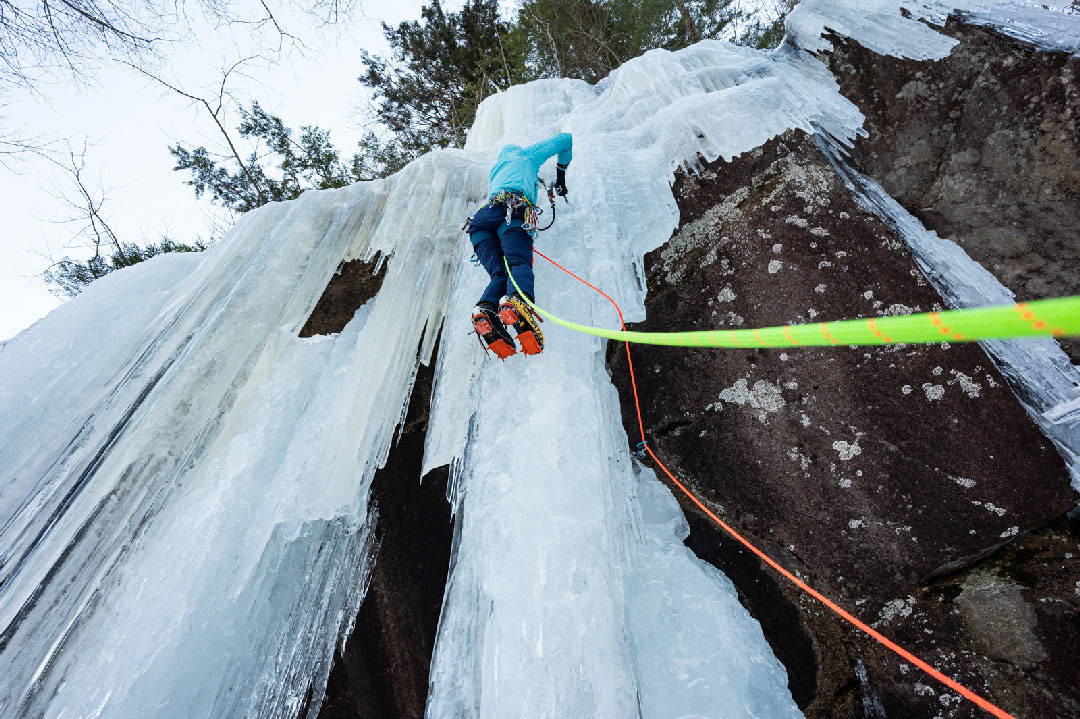an ice climber climbing with bright Sterling rope