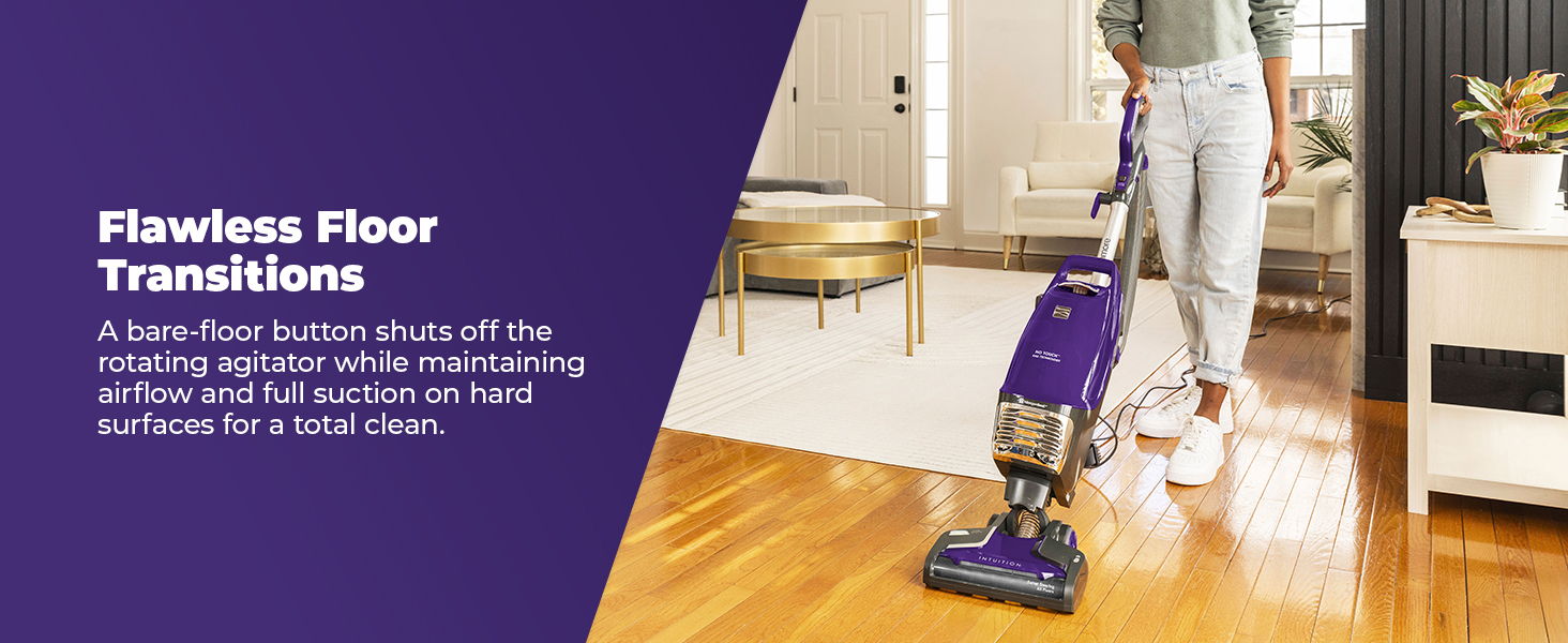 Person using a vacuum cleaner on hardwood floors in a modern living space.