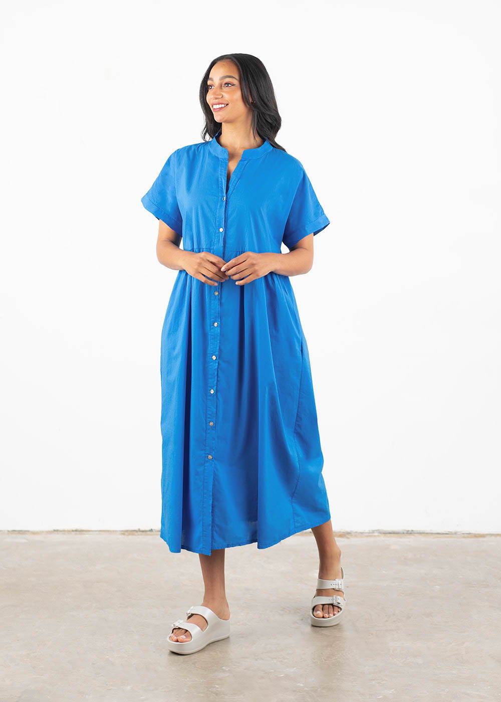 A model wearing a loose, oversized midi dress in a vibrant cobalt blue