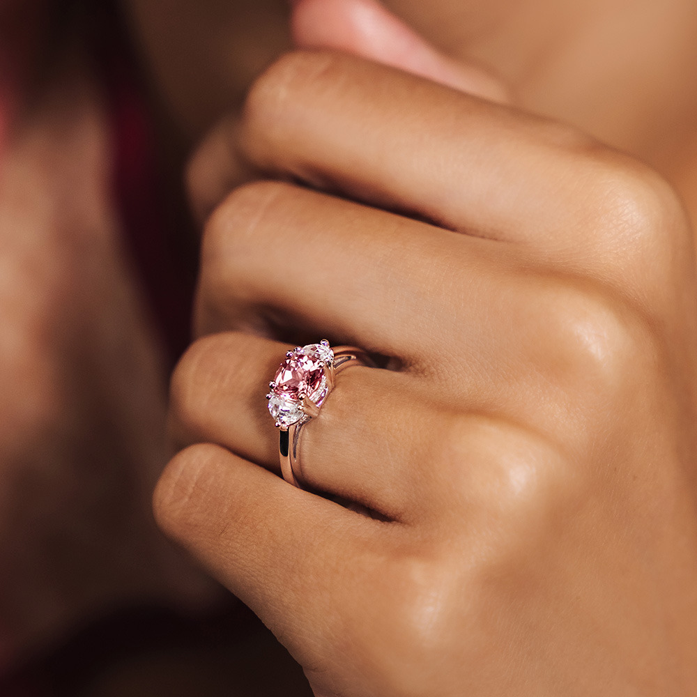 Stunning three stone pink sapphire ring shown worn on hand