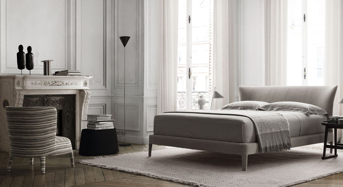 Modern maxalto bedroom with a Febo bed, armchair, and decorative fireplace