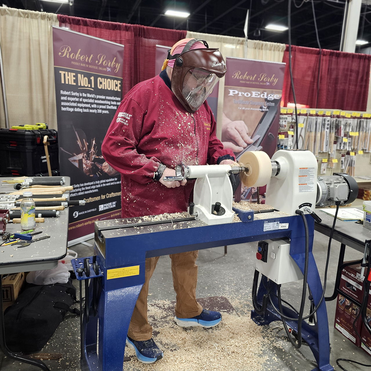 Person using a wood lathe at a craft fair.