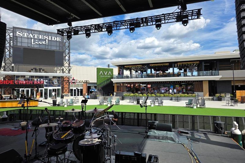 View from the Stateside Live! stage in Philadelphia looking out over the lawn toward AVA Rooftop Bar, home of The Big Dill pickle party on November 14