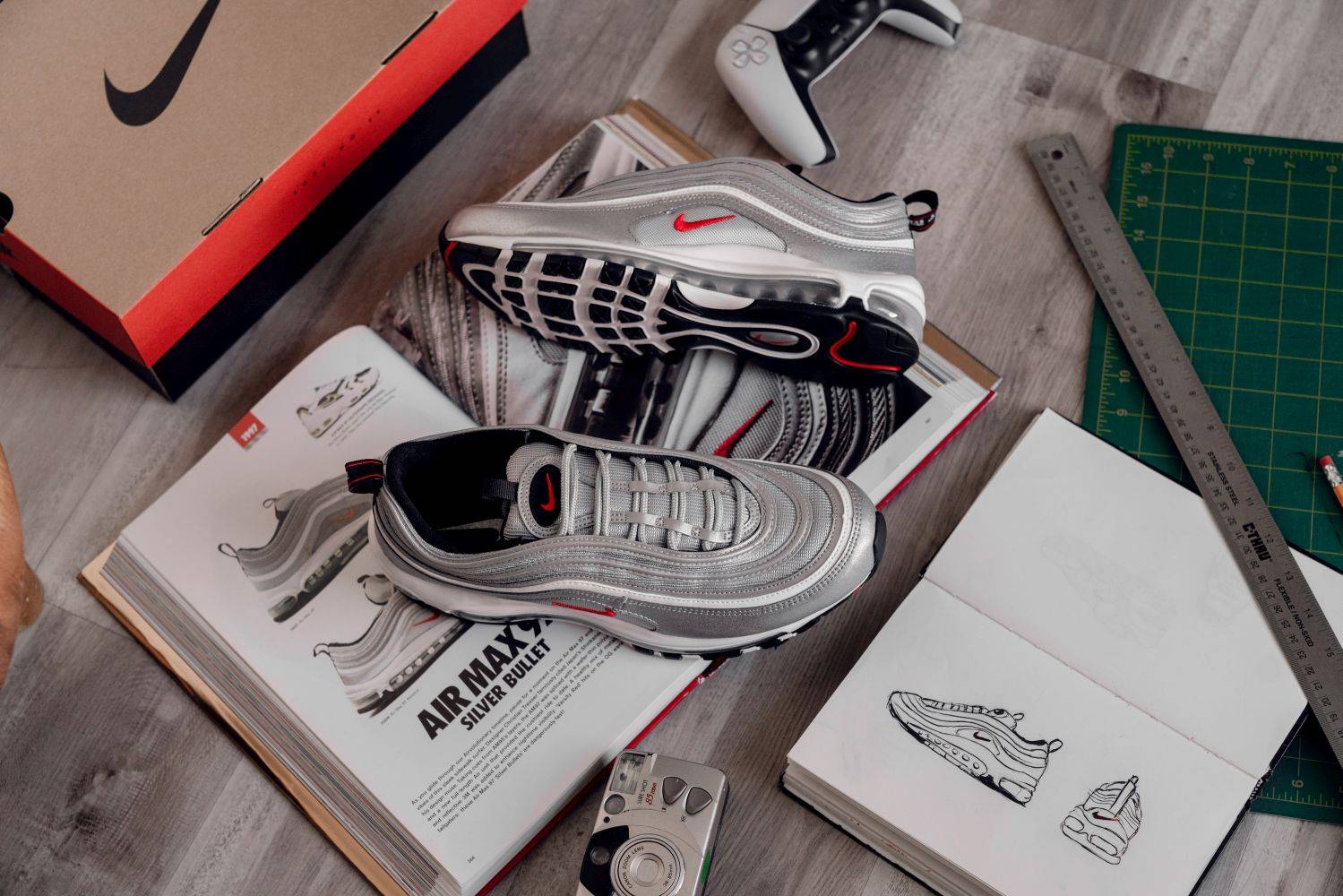 nike air max 97 silver bullet on top of notebook