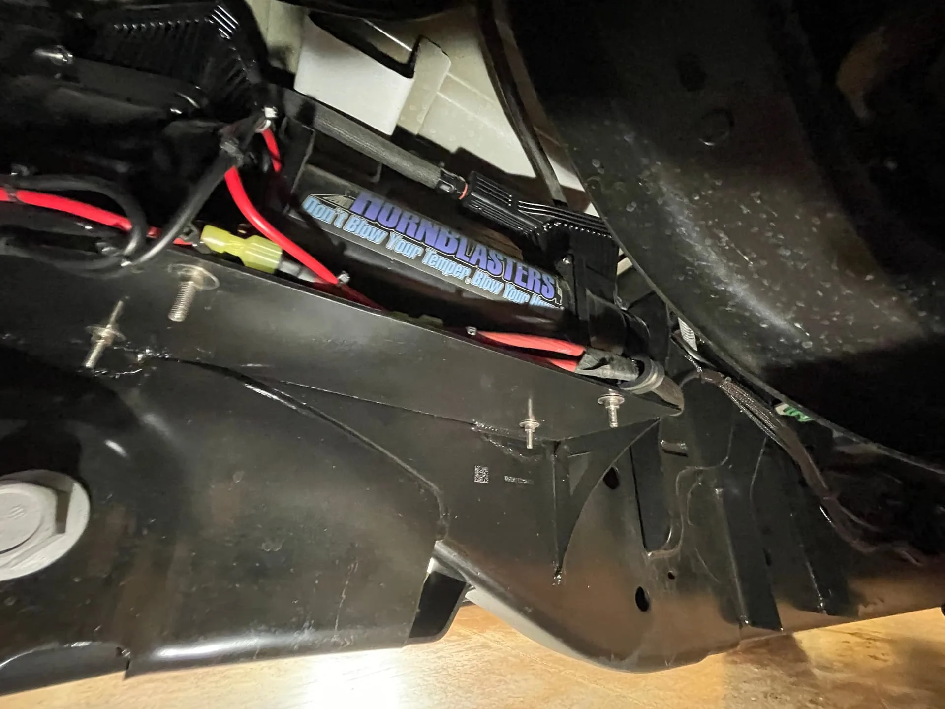 Close-up HornBlasters undercarriage component with branded sticker and red wiring photo 8