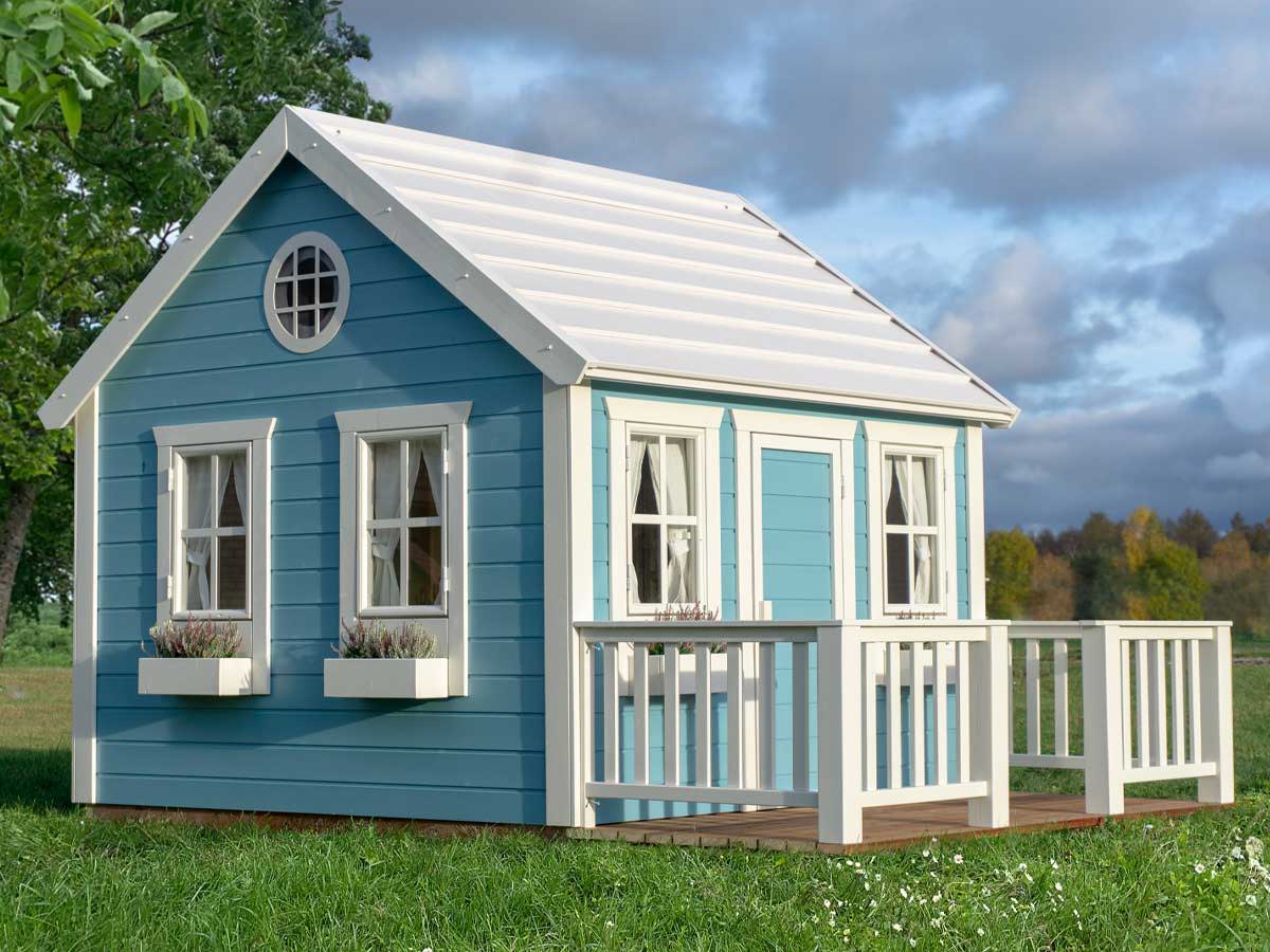 Wooden playhouse in blue color with white roof and flower boxes and a round top window on green background by WholeWoodPlayhouses