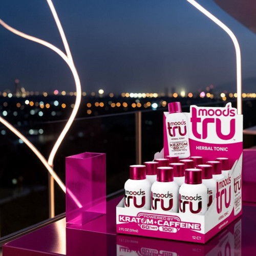 Display of mood-enhancing drink bottles against a city night skyline.