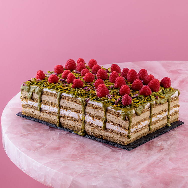 Pistachio and rose cream sponge tray cake with fresh raspberries