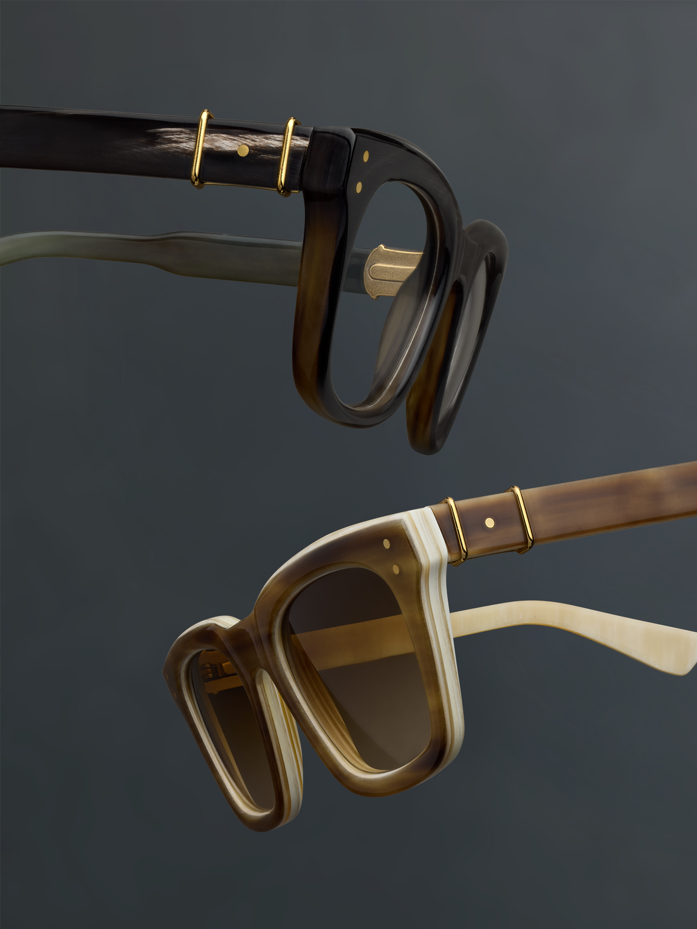 Two pairs of stylish Robert Marc Horn sunglasses against a dark background.