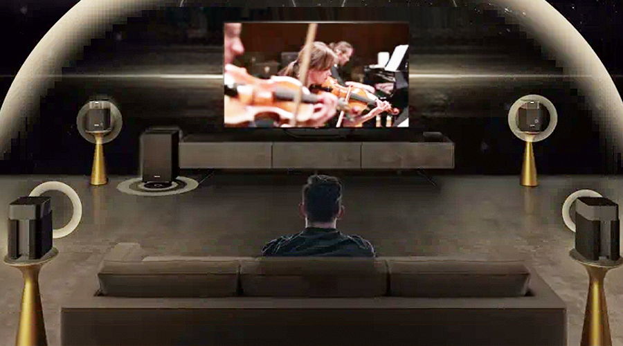 Person watching a concert on a large screen in a modern living room.