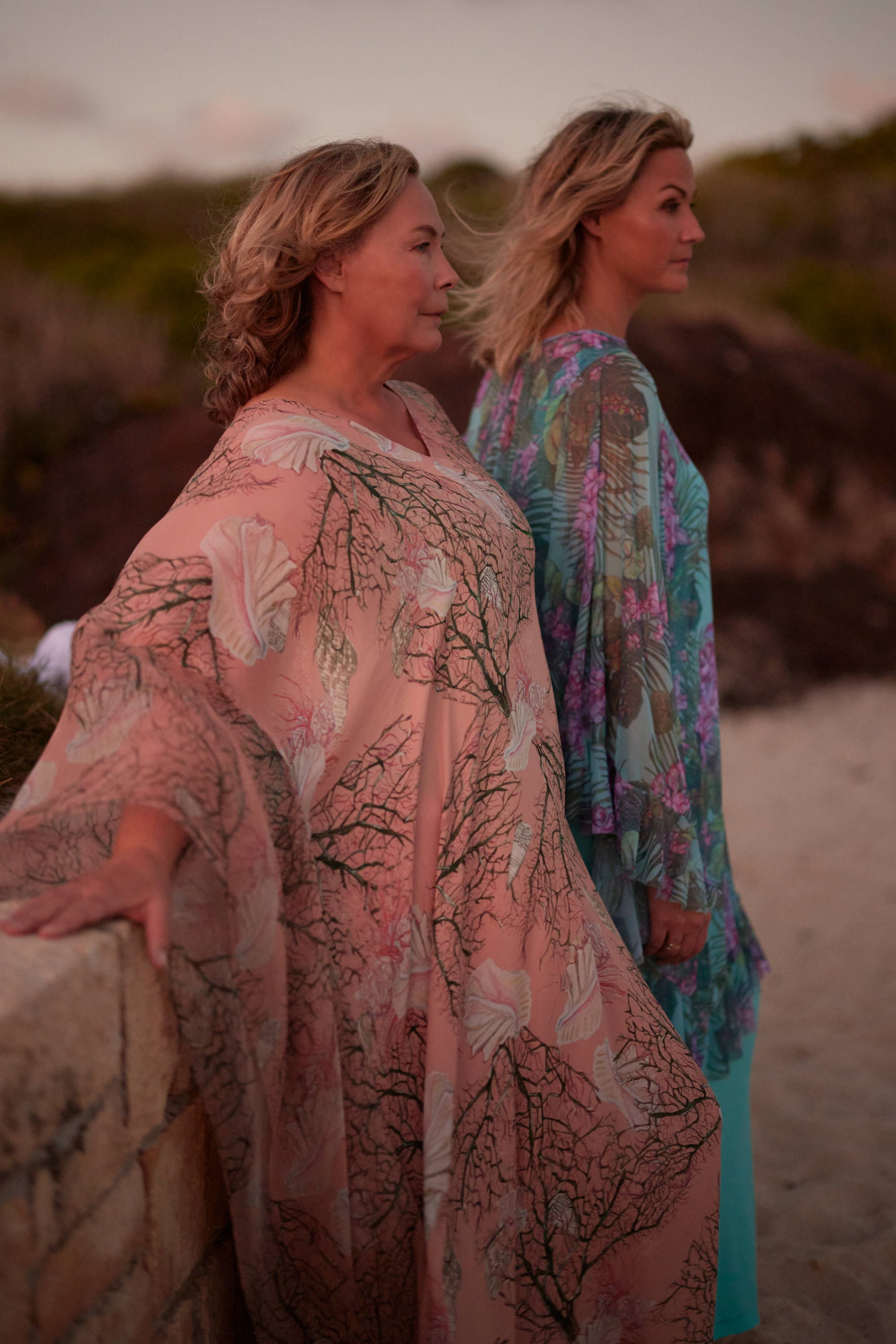 Ala and Sunny wearing printed kaftans on the beach in Antigua