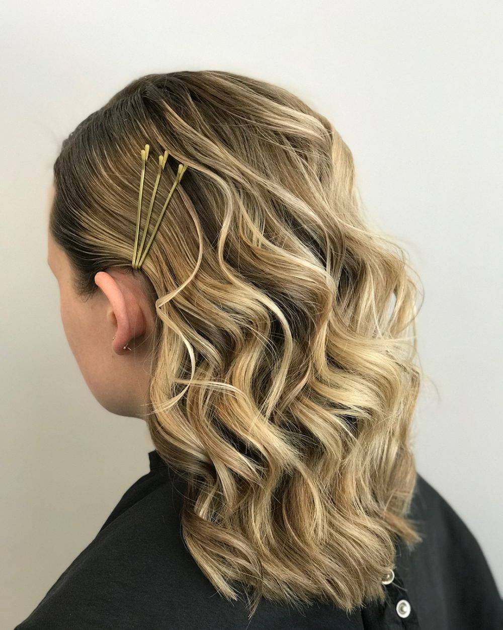 Girl with curly hair and gold bobby pins