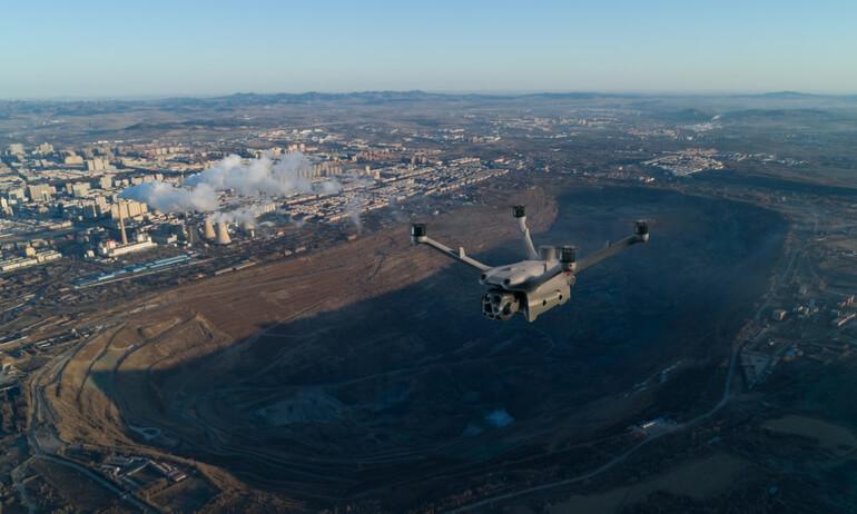 DJI Matrice 4 Series drone flying over an open-pit mine for aerial monitoring and surveying