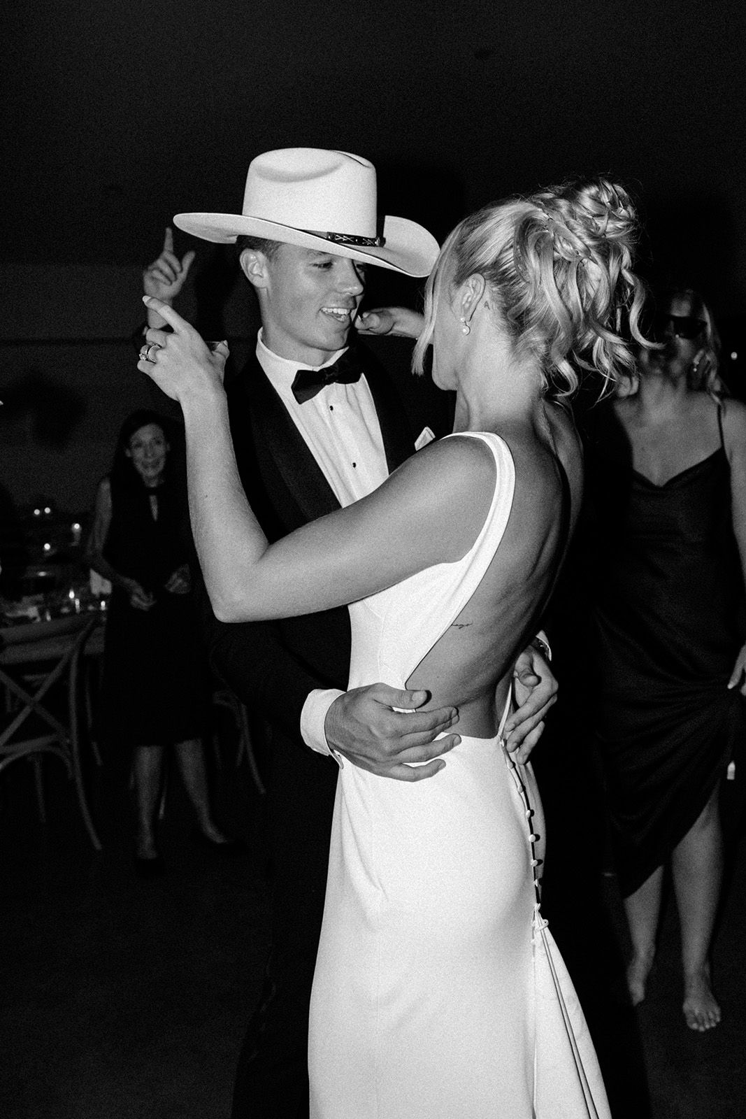 Couple dancing elegantly in formal attire at an event.