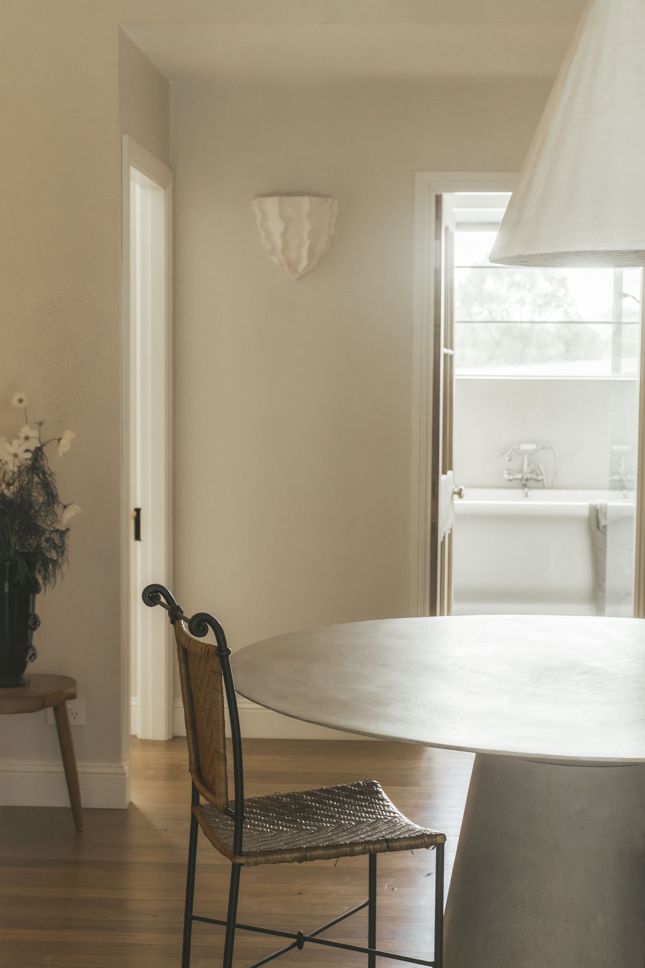 Interior room with a round table, chair, and a doorway to another space.
