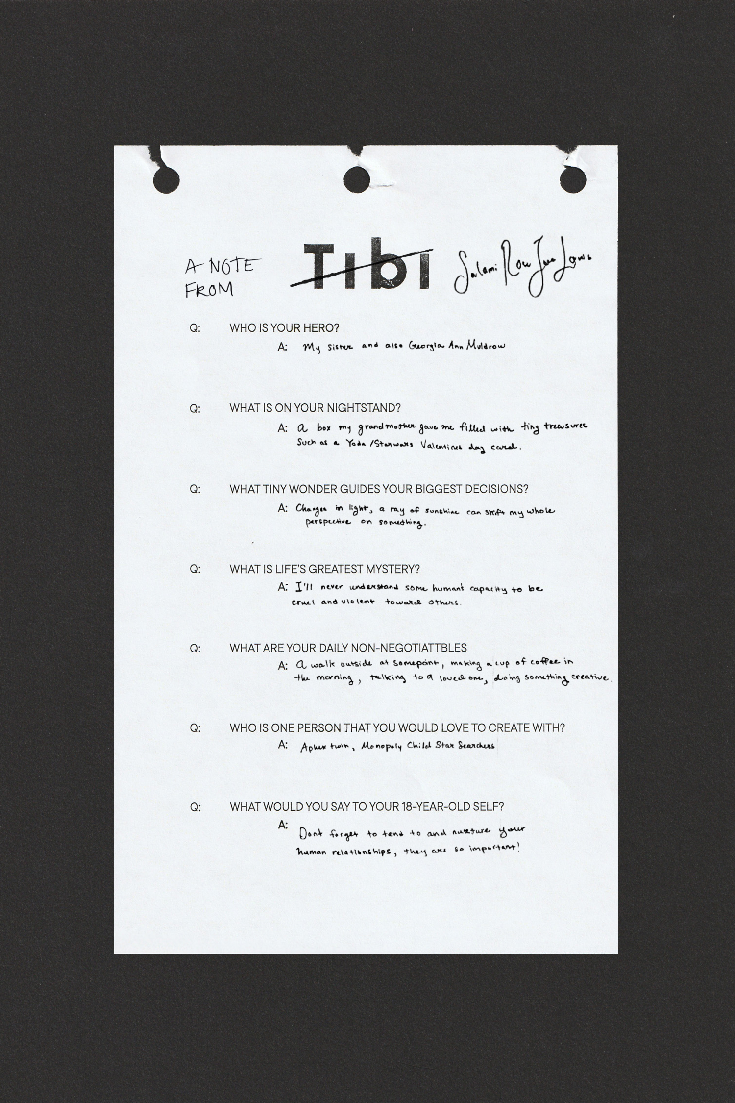A note on white paper with handwritten text and questions, pinned on a black background.