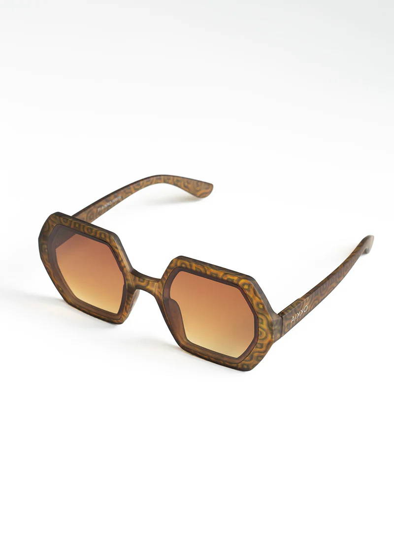 A pair of vintage inspired hexagonal sunglasses with a vown tortoiseshell patterned frames a dn brown lenses