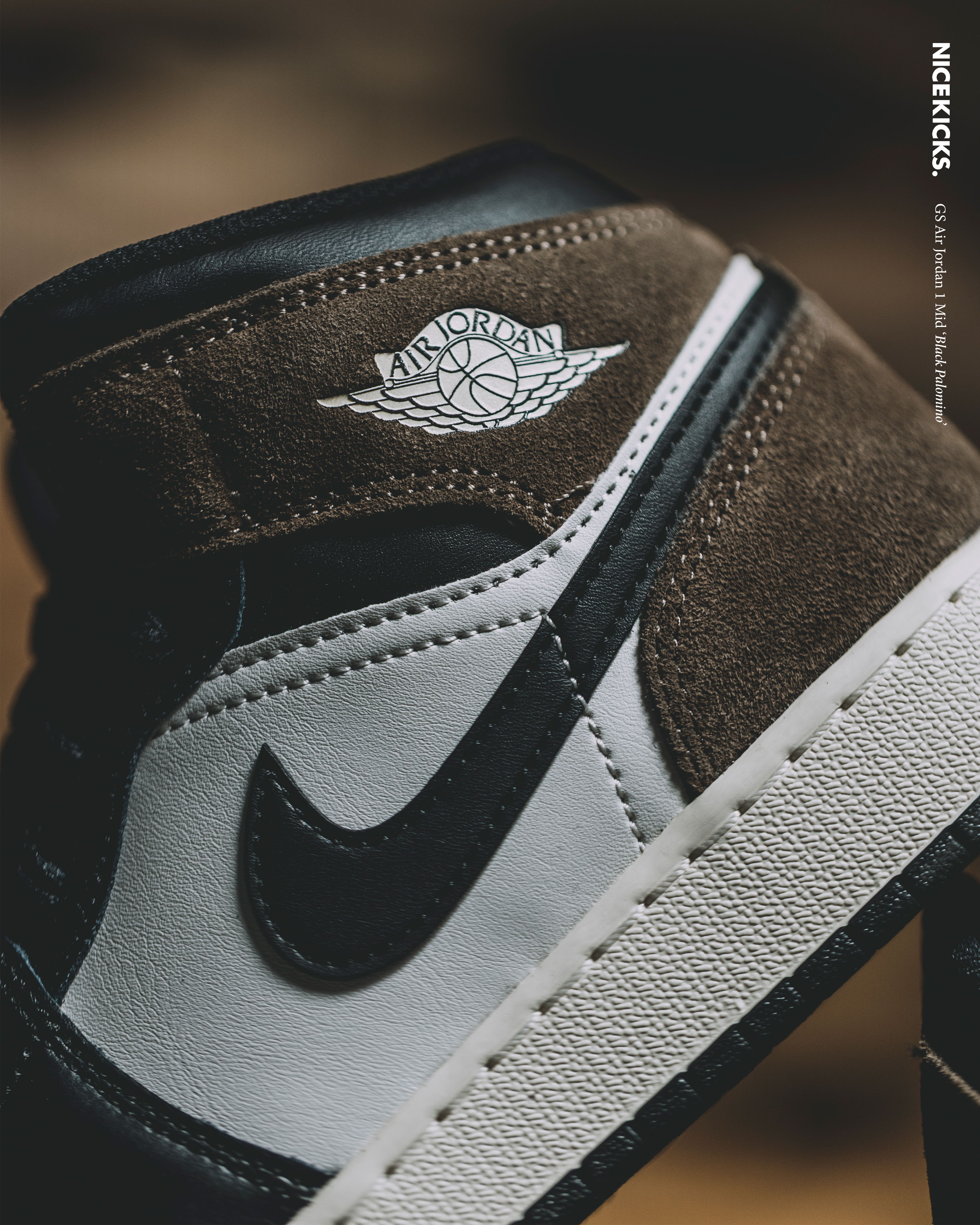 Close-up of a brown and white Nike sneaker with logo.