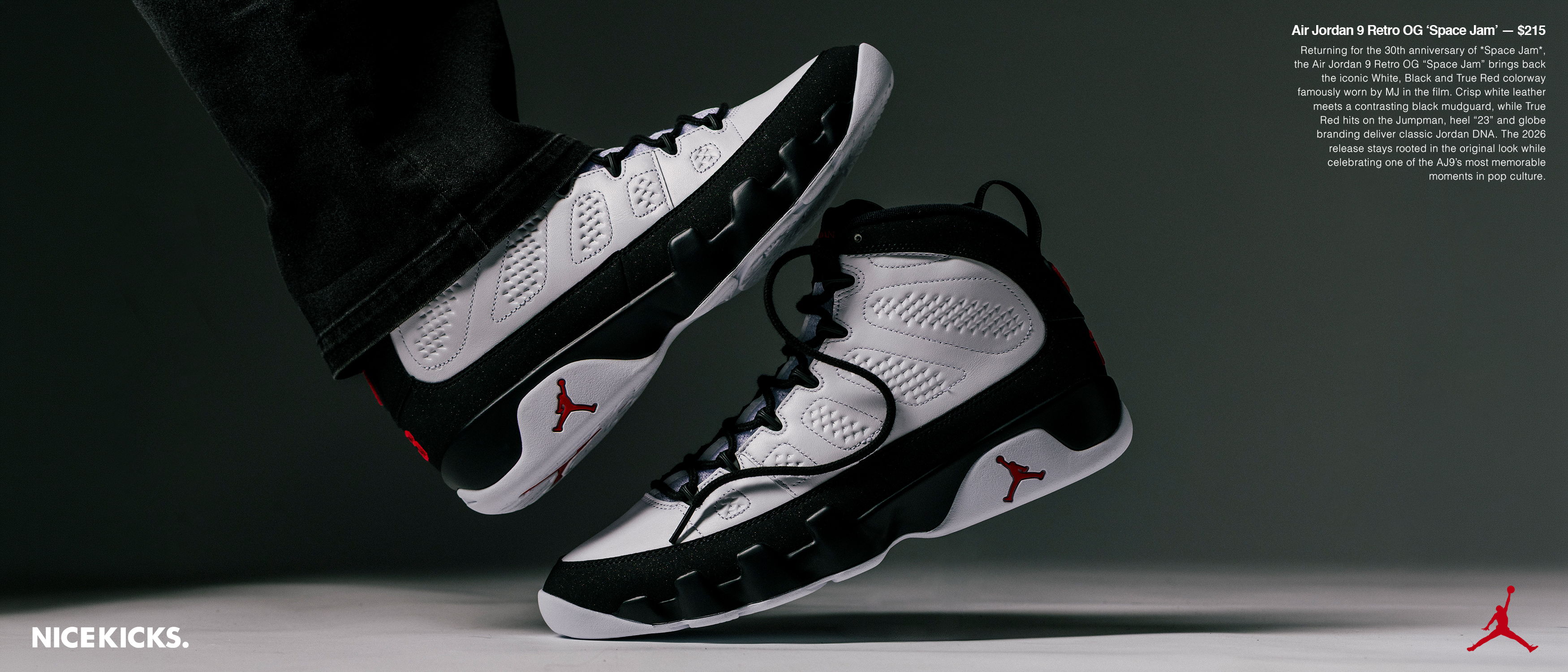 A pair of black and white basketball shoes in mid-air.