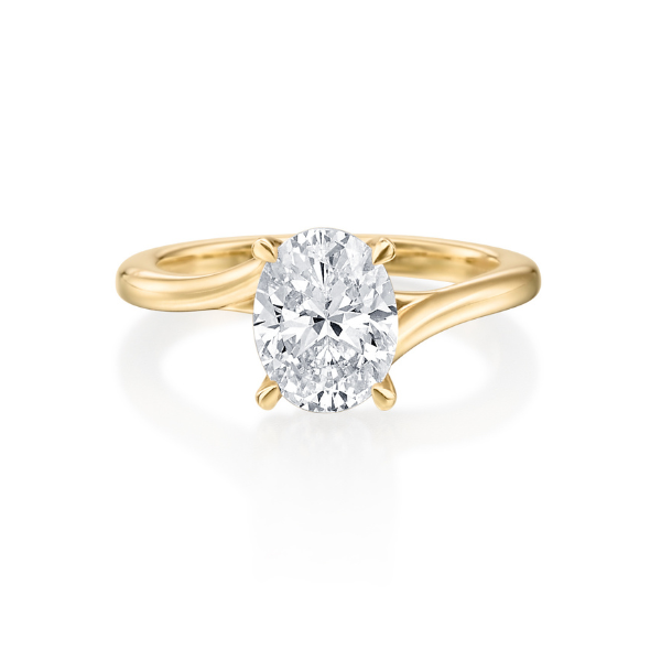 Gold ring featuring an oval diamond center stone.