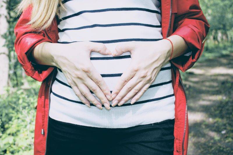 Pregnant Woman Holding Her Stomach