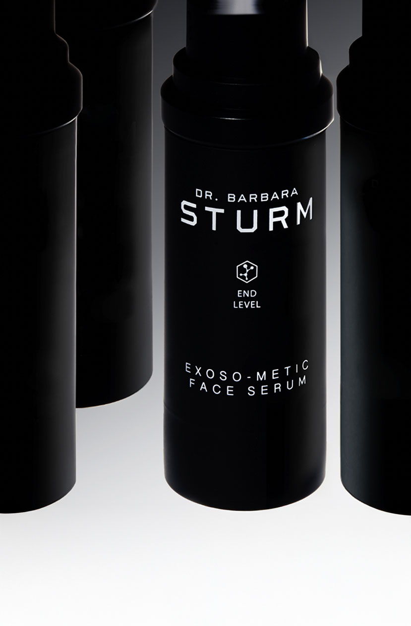 Black bottle of Dr. Barbara Sturm Exosome Face Serum on a gradient background.