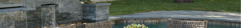Wooden dining table with six chairs beside a pool.