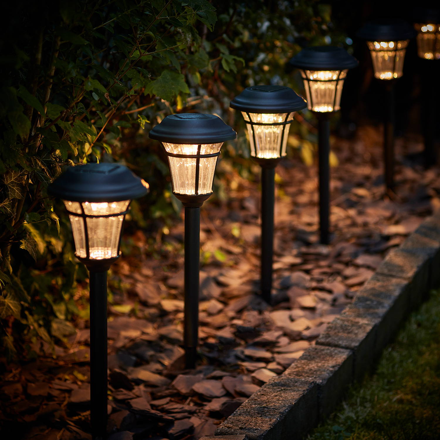 Richmond solar stake lights illuminated along garden path