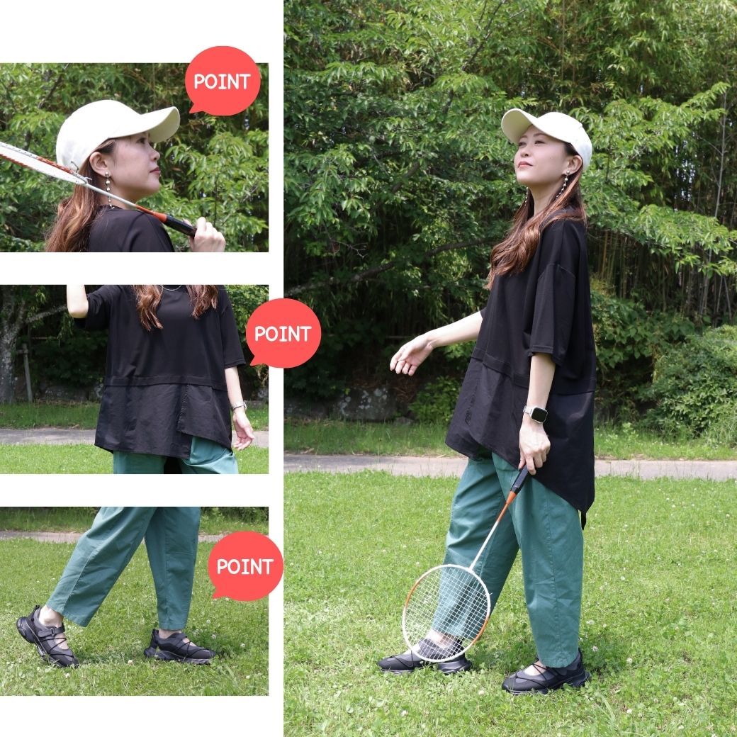 Person in casual outfit holding a badminton racket outdoors in a park.