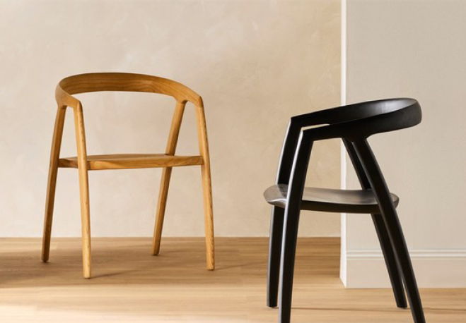 Two modern chairs, one wooden and one black, against a neutral background.