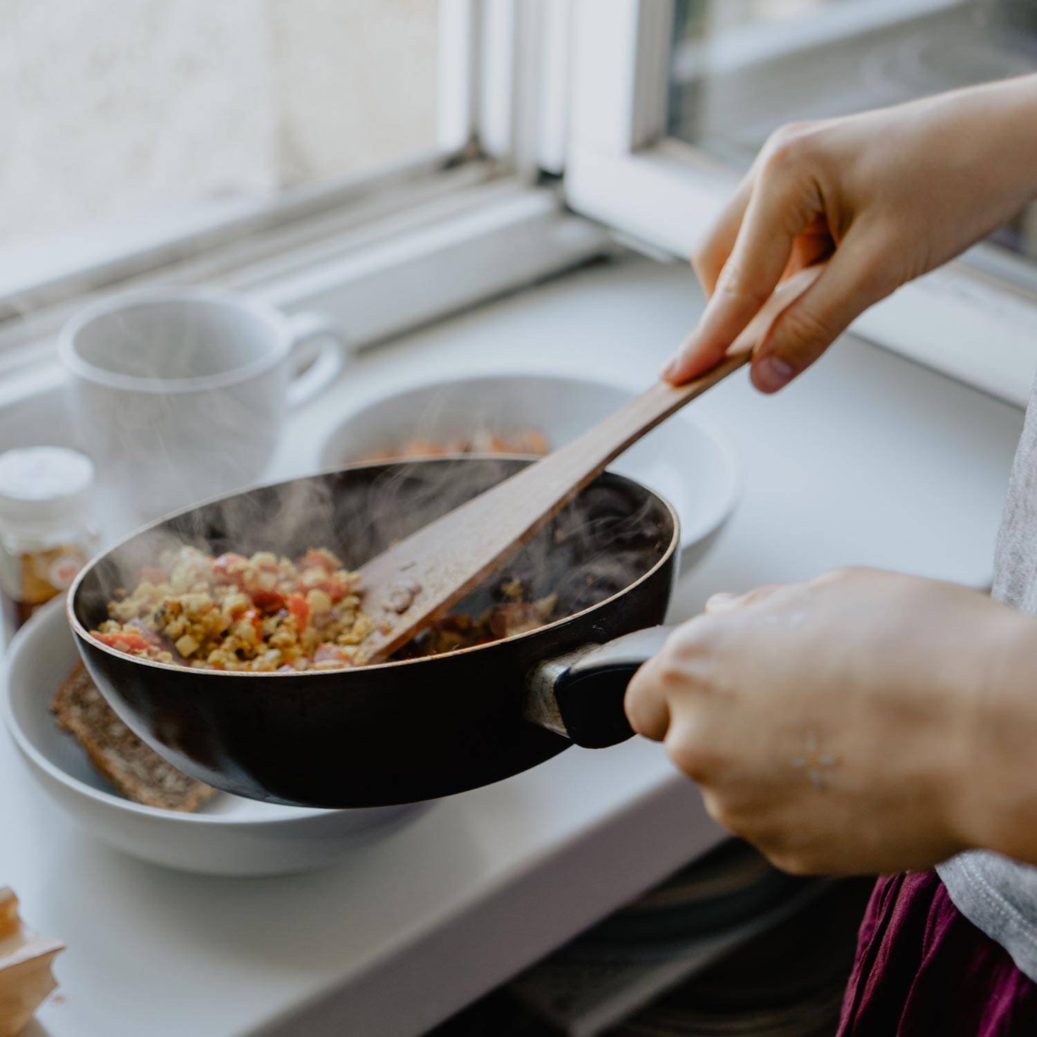 Person cooking a meal in their kitchen.