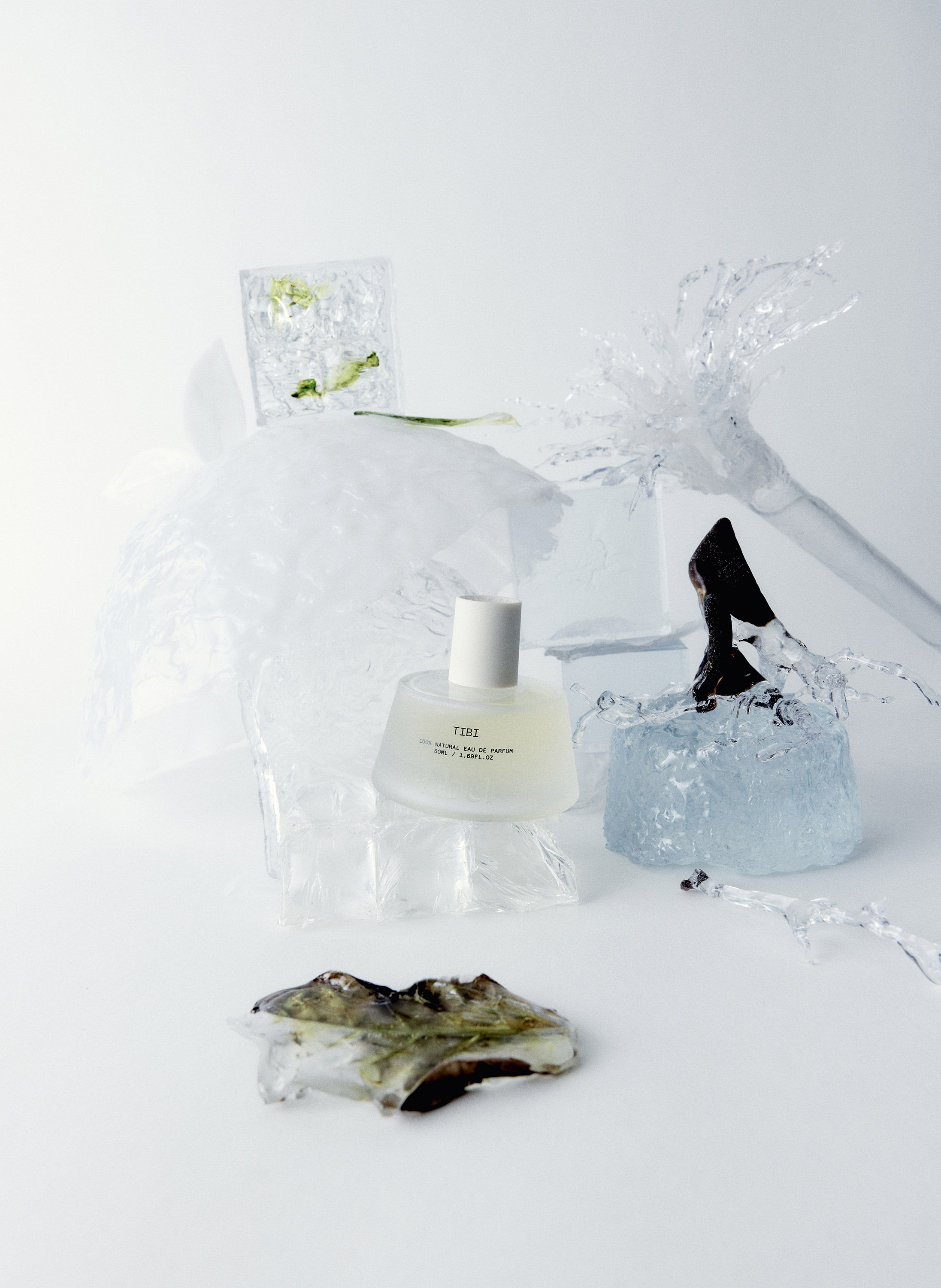 A perfume bottle surrounded by decorative elements and a textured object.