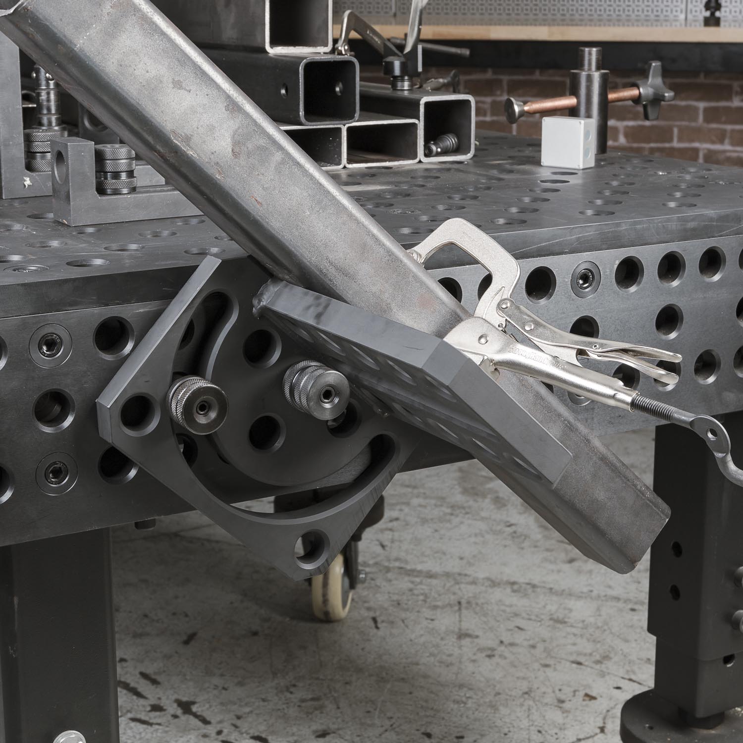 Metalworking tool mounted on a workbench with various attachments and fixtures.