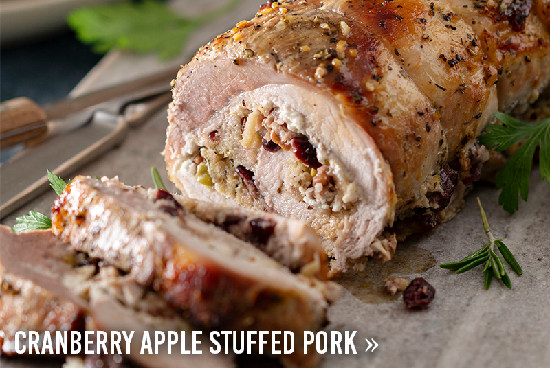 Sliced pork roast filled with cranberry apple stuffing and garnished with fresh herbs. View the Cranberry Apple Stuffed Pork recipe