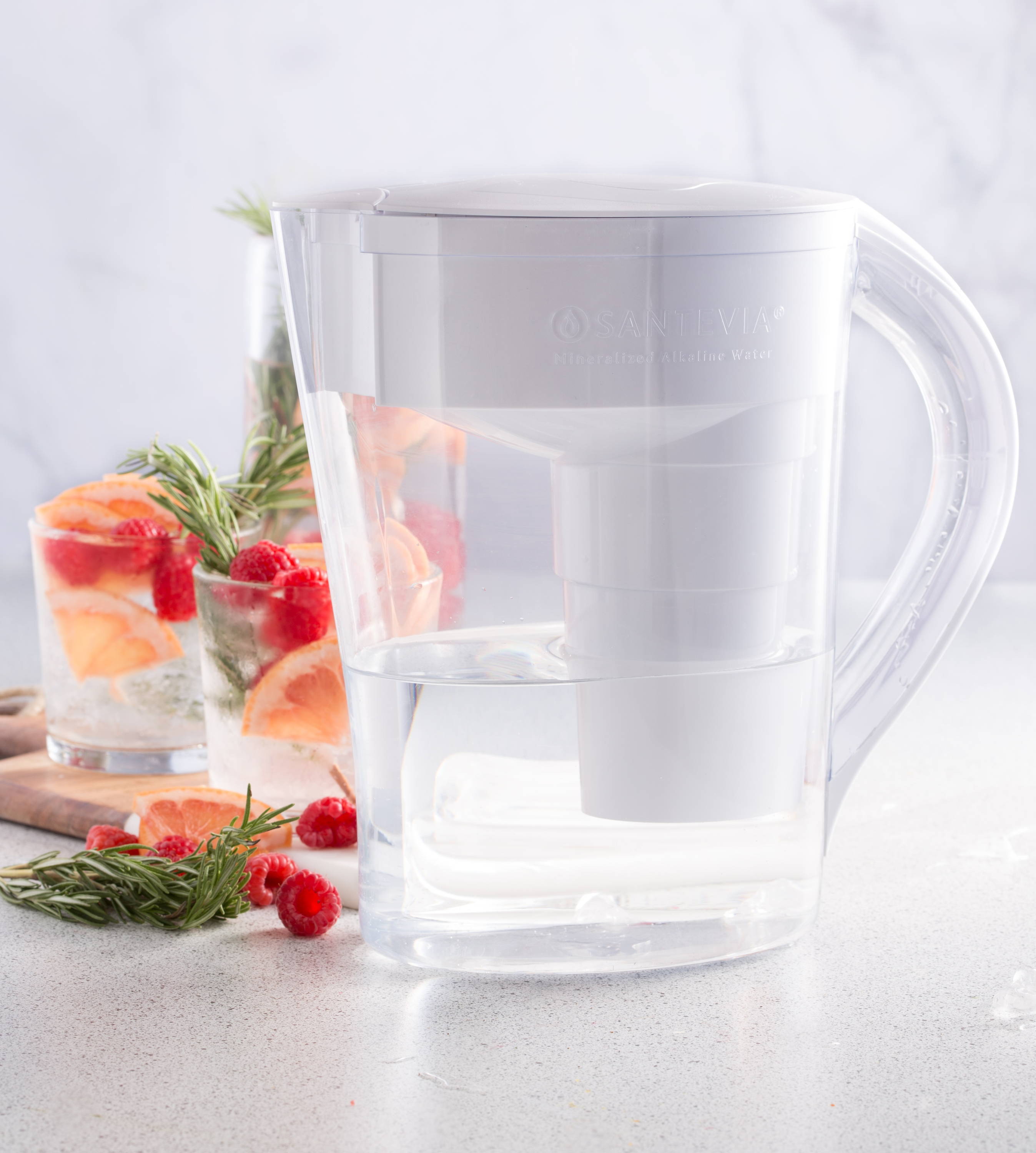A Santevia MINA Pitcher with rosemary, raspberry, and grapefruit infused alkaline water