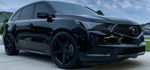 Front three-quarter Carrie's black 2017 Acura MDX with aftermarket wheels parked on suburban driveway photo 1