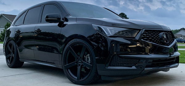 Front three-quarter Carrie's black 2017 Acura MDX with aftermarket wheels parked on suburban driveway photo 1