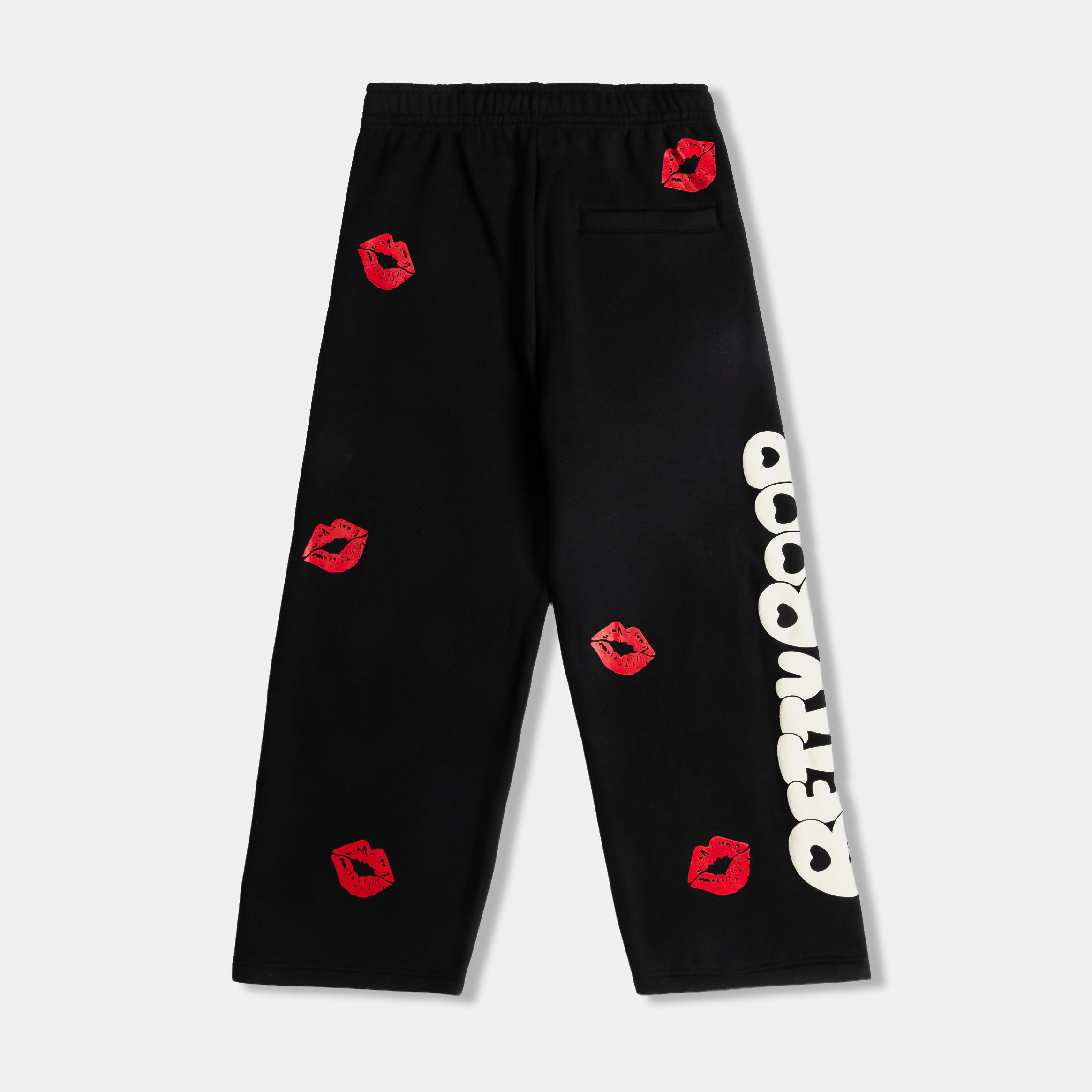 Black pants with red lip prints and white text.