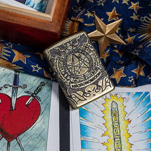 Antique Brass Book of the Dead lighter, laying with tarot cards
