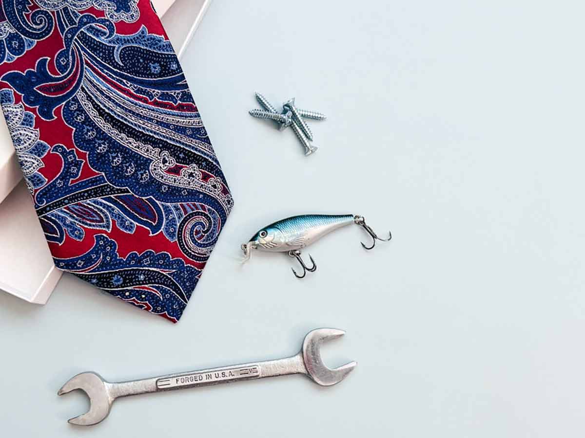 Father’s Day gift setup with a paisley necktie, gift box, and assorted tools for Dad.
