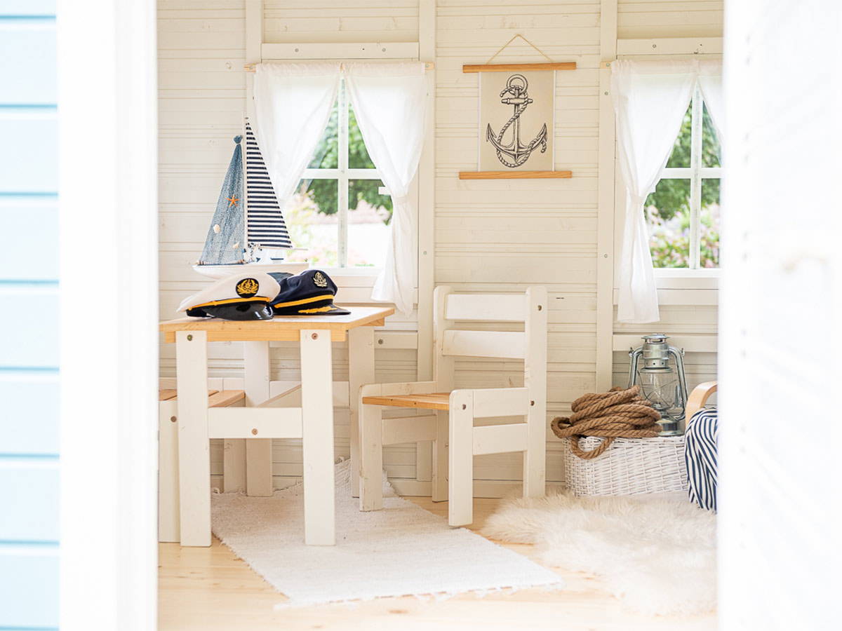Outdoor Playhouse Bluebird inside view with kids furniture and nautical decorations by WholeWoodPlayhouses