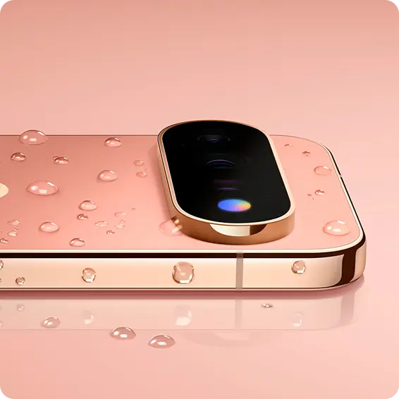 Close-up of a rose gold smartphone with water droplets on it.