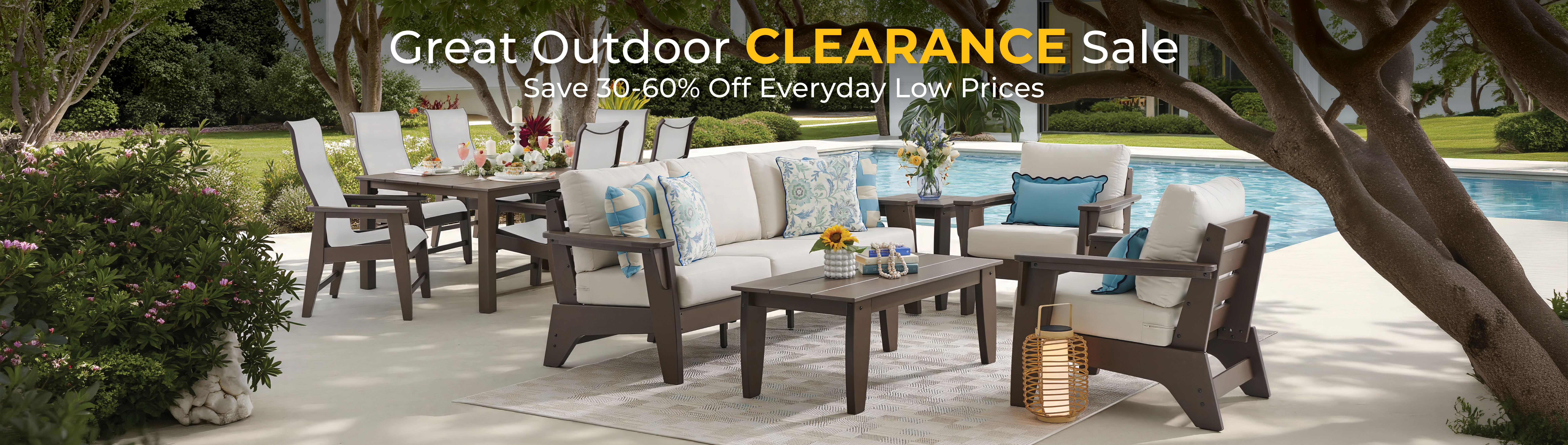 Outdoor furniture set by a pool with a clearance sale banner.