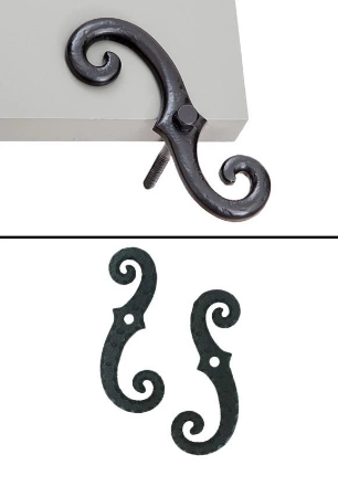 Two decorative metal hooks with curly designs, one attached to a surface.