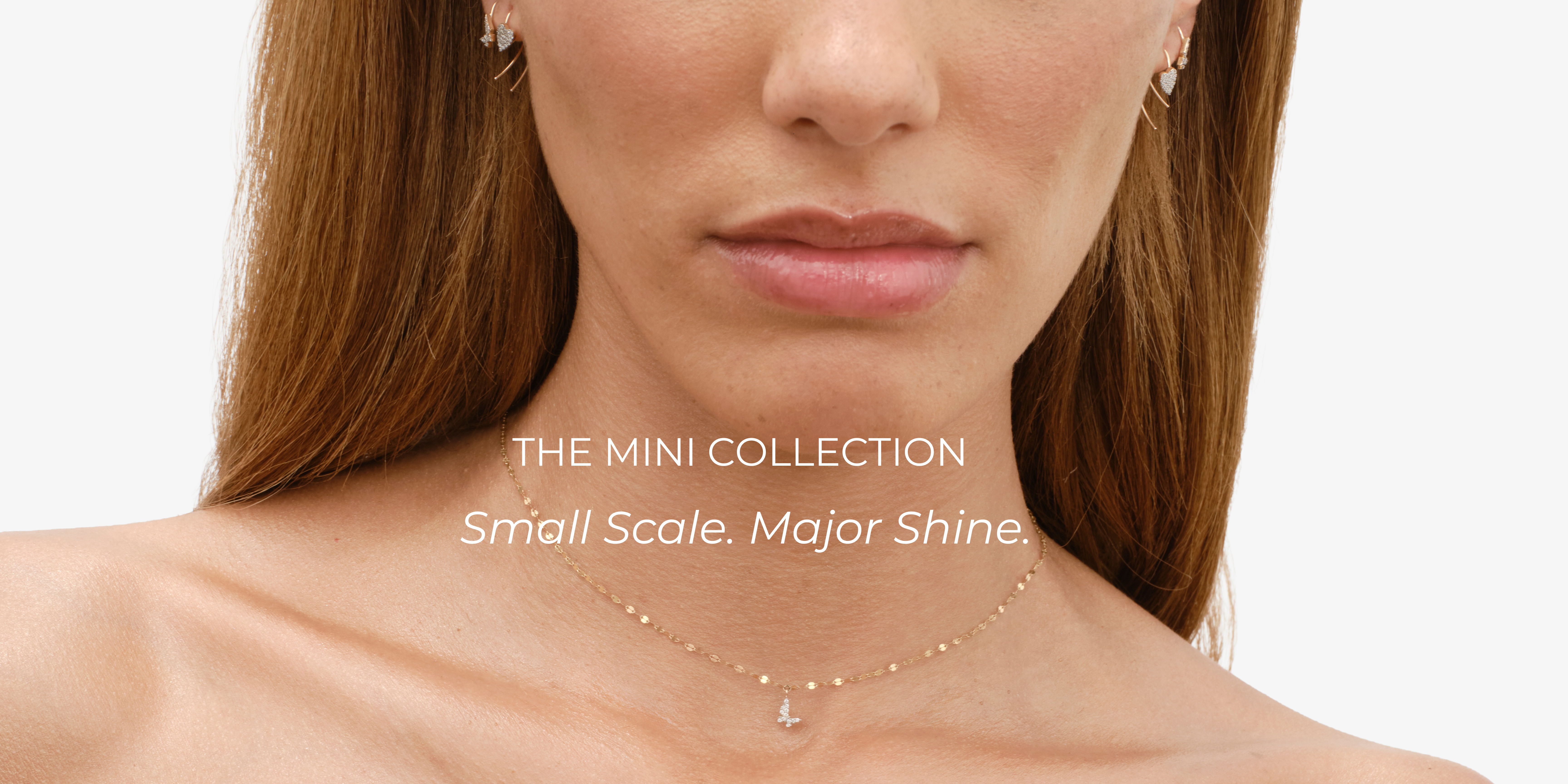 Model wearing jewelry from the Mini Collection, featuring a subtle necklace.
